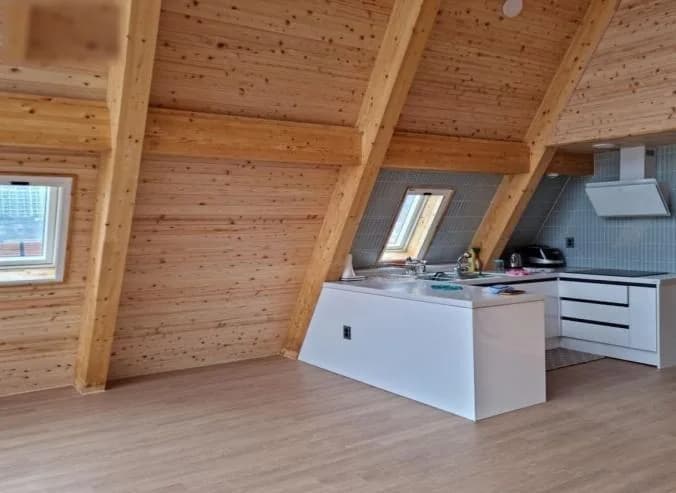Tiny Villa A2 interior — kitchen under the A-frame ceiling