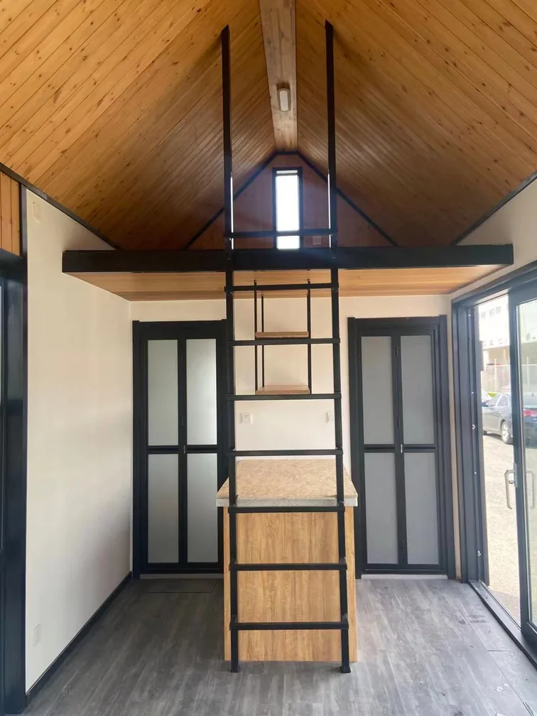 KyangLab Tiny Villa B2 — interior with loft ladder and spruce ceiling