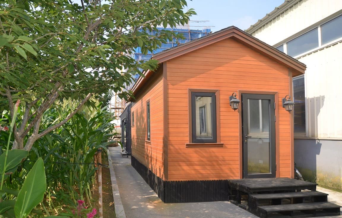 KyangLab Tiny Villa T1 — built exterior view with pine wood cladding and front door