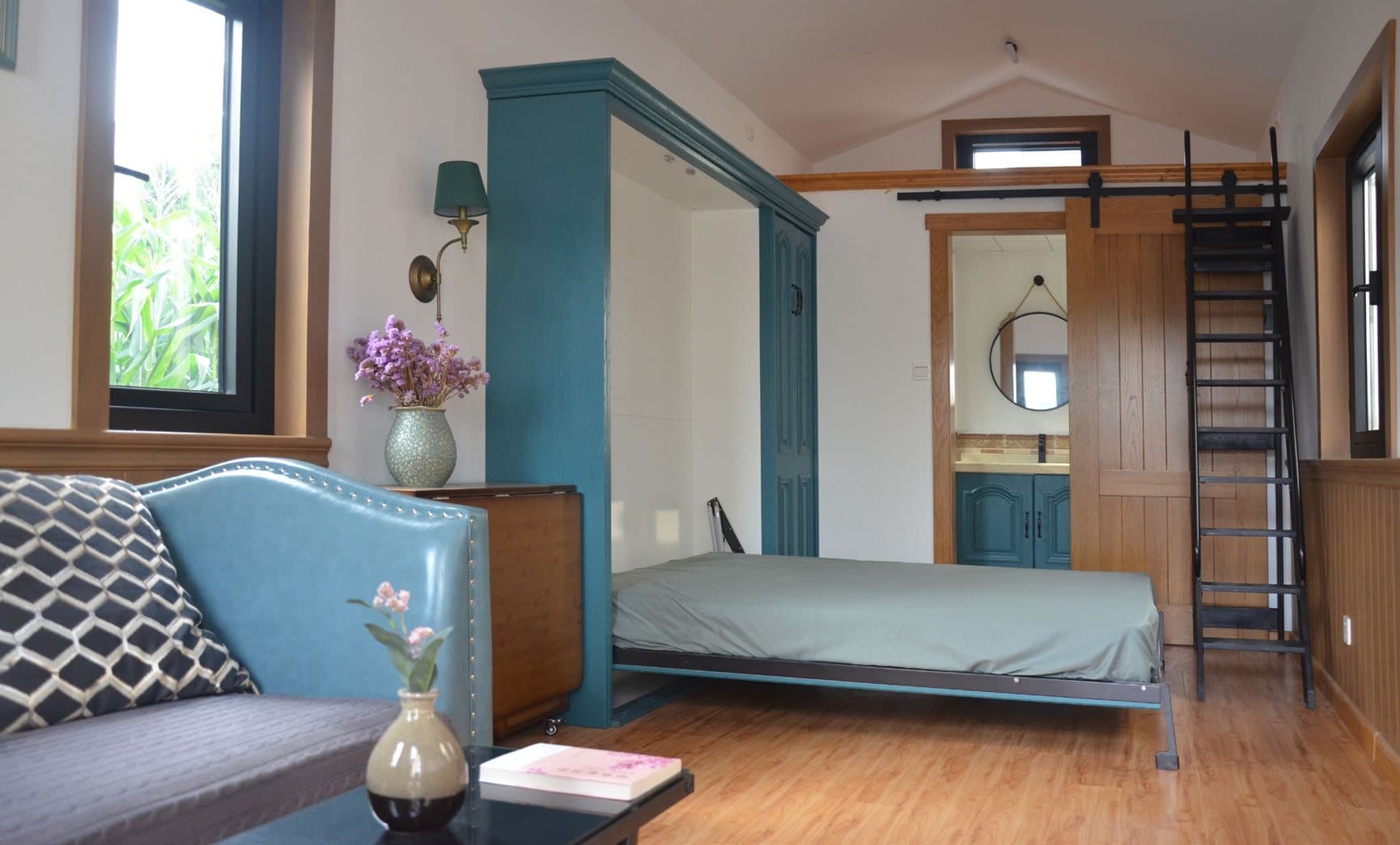 Tiny Villa T1 interior with folding bed, loft ladder and compact living space